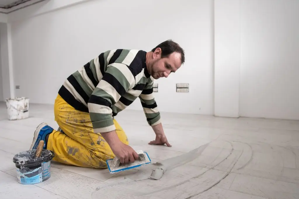 man finishing tile floor